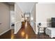 Inviting hallway with hardwood floors, neutral walls, and modern decor leading to various rooms at 2914 Hiddenbrook Way, Indian Land, SC 29707