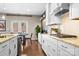 Bright kitchen showcasing white cabinetry, granite countertops, stainless steel appliances, and natural light at 2914 Hiddenbrook Way, Indian Land, SC 29707