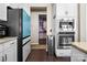 Modern kitchen featuring stainless steel appliances, white cabinetry, and sleek, stylish design elements at 2914 Hiddenbrook Way, Indian Land, SC 29707