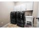Functional laundry area with a side-by-side washer and dryer, plus cabinet storage at 2914 Hiddenbrook Way, Indian Land, SC 29707