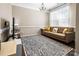 Cozy living room offers a decorative rug, chandelier lighting, and comfortable seating at 2914 Hiddenbrook Way, Indian Land, SC 29707