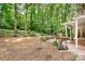 Backyard featuring a grill, a covered porch, a manicured lawn and mature trees at 329 N Oakwood Dr, Statesville, NC 28677