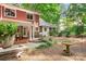 Backyard with covered patio, lush landscaping and bird bath at 329 N Oakwood Dr, Statesville, NC 28677