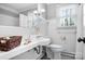 Cozy bathroom featuring subway tiles, unique sink and toilet, window and decorative accessories at 329 N Oakwood Dr, Statesville, NC 28677