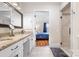 Bright bathroom featuring granite countertops, white cabinets, and a glass-enclosed shower, seamlessly connecting to the bedroom at 329 N Oakwood Dr, Statesville, NC 28677