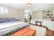 Comfortable bedroom with hardwood floors, windows, desk with shelves and wooden chest at 329 N Oakwood Dr, Statesville, NC 28677