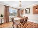 Bright dining room with hardwood floors, modern lighting, and large windows, ideal for Gathering meals and gatherings at 329 N Oakwood Dr, Statesville, NC 28677