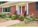 Inviting brick front entrance with a red door and manicured landscaping at 329 N Oakwood Dr, Statesville, NC 28677