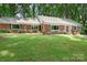 Traditional single story brick home with beautiful lawn and mature trees at 329 N Oakwood Dr, Statesville, NC 28677