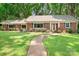 Charming brick home with a welcoming walkway and lush green lawn at 329 N Oakwood Dr, Statesville, NC 28677