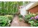 Side yard with stone walkway and lush, colorful landscaping at 329 N Oakwood Dr, Statesville, NC 28677