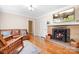 Cozy living room with a stone fireplace, hardwood floors, and comfortable seating at 329 N Oakwood Dr, Statesville, NC 28677
