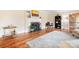 Sunlit living room featuring hardwood floors, fireplace, and tastefully decorated space, perfect for a cozy home environment at 329 N Oakwood Dr, Statesville, NC 28677