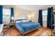 Comfortable main bedroom with hardwood floors, natural light, and calm decor, creating a peaceful and relaxing retreat at 329 N Oakwood Dr, Statesville, NC 28677