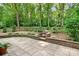 Tiled patio with a stone fire pit and a metal fence at 329 N Oakwood Dr, Statesville, NC 28677