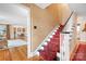 Elegant staircase featuring a red patterned runner, white banister, and classic hardwood flooring at 329 N Oakwood Dr, Statesville, NC 28677