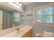 Bright bathroom featuring a large mirror, window, and blue accent wall at 3430 Olde Oak Ln, Gastonia, NC 28056