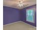 Bedroom with purple walls, beige carpet, ceiling fan and a window that offers natural light at 3430 Olde Oak Ln, Gastonia, NC 28056