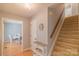 Hallway with stairs, neutral wall colors, and views into the dining room at 3430 Olde Oak Ln, Gastonia, NC 28056