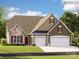 Charming two-story home featuring stone accents, tan siding, well-kept lawn, and a spacious two-car garage at 4116 Camden Glen Rd, Lancaster, SC 29720