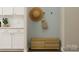 Neat entryway with a wooden bench, white cabinets, and decorative wall art at 4122 Camden Glen Rd, Lancaster, SC 29720