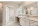 Bathroom with a double vanity, white cabinets, and a large mirror at 4134 Camden Glen Rd, Lancaster, SC 29720
