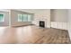 Bright living room with a fireplace, built-in cabinets, and large windows overlooking the yard at 4134 Camden Glen Rd, Lancaster, SC 29720