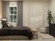 Comfortable bedroom featuring a cozy bed, chair, and natural light, creating a relaxing and stylish space at 4144 Camden Glen Rd, Lancaster, SC 29720