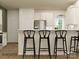 Open-concept kitchen featuring white cabinets, stainless steel appliances, and a breakfast bar at 4144 Camden Glen Rd, Lancaster, SC 29720