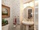 Charming powder room with vintage wallpaper, pedestal sink, and classic accents at 419 Park Ridge Rd, Albemarle, NC 28001