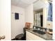 Small bathroom featuring a black toilet, vanity with black marble counter and a shower with white curtain at 419 Park Ridge Rd, Albemarle, NC 28001