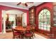 Elegant dining room with red accent walls and a beautiful view of the backyard at 419 Park Ridge Rd, Albemarle, NC 28001
