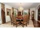 Elegant dining room with crystal chandelier, large windows, and hardwood floors at 419 Park Ridge Rd, Albemarle, NC 28001