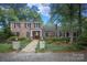 Charming brick home with a manicured lawn, stone walkway, and a covered front entrance at 419 Park Ridge Rd, Albemarle, NC 28001