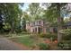 Brick home with manicured landscaping, stone pathway and many mature trees at 419 Park Ridge Rd, Albemarle, NC 28001