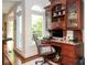 Comfortable home office with built-in desk and cabinetry situated next to a bright window at 419 Park Ridge Rd, Albemarle, NC 28001