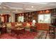 Inviting living room boasts custom built-ins, coffered ceilings, and beautiful hardwood floors at 419 Park Ridge Rd, Albemarle, NC 28001