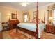 Charming main bedroom with a four-poster bed, desk, and a custom rug at 419 Park Ridge Rd, Albemarle, NC 28001