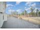 Wide angle shot of a large wood deck with railings and wooded views beyond at 4604 Howie Ln, Harrisburg, NC 28075