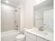 Bathroom featuring a combined tub and shower, light tiling, and a white vanity with a modern faucet at 4604 Howie Ln, Harrisburg, NC 28075