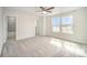 Bright bedroom with plush carpet, double windows offering natural light, and an en-suite bathroom at 4604 Howie Ln, Harrisburg, NC 28075