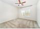 Bright bedroom with plush carpet flooring, ceiling fan and a window view to the home's outdoor deck at 4604 Howie Ln, Harrisburg, NC 28075