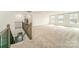 Bonus room featuring plush carpet, natural light, and iron railing, creating a cozy and inviting space at 4604 Howie Ln, Harrisburg, NC 28075