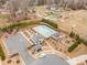Aerial view of a community pool area featuring a large swimming pool, clubhouse, and playground at 4604 Howie Ln, Harrisburg, NC 28075