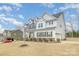 Charming two-story home featuring white siding and dark shutters with a well-maintained lawn at 4604 Howie Ln, Harrisburg, NC 28075