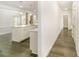 Hallway leading to an open kitchen featuring a large island, stainless appliances, and a pantry at 4604 Howie Ln, Harrisburg, NC 28075