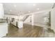 An open-concept kitchen with white cabinets, a large island, and stainless steel appliances at 4604 Howie Ln, Harrisburg, NC 28075