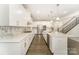 Modern kitchen boasts sleek countertops, white cabinetry, stainless appliances, and island with a sink at 4604 Howie Ln, Harrisburg, NC 28075
