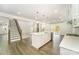 Open layout: kitchen with island flows into living room with fireplace and deck access at 4604 Howie Ln, Harrisburg, NC 28075