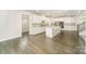 Stylish kitchen featuring marble backsplash, white cabinets, stainless steel appliances, and large island at 4604 Howie Ln, Harrisburg, NC 28075